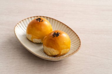 Design concept of Moon cake yolk pastry, mooncake for Mid-Autumn Festival holiday on wooden table background