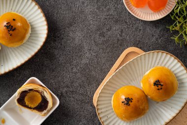 Design concept of Moon cake yolk pastry, mooncake for Mid-Autumn Festival holiday on gray table background