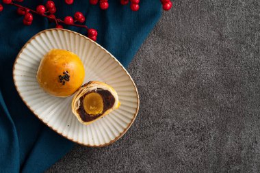 Design concept of Moon cake yolk pastry, mooncake for Mid-Autumn Festival holiday on gray table background