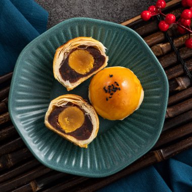 Design concept of Moon cake yolk pastry, mooncake for Mid-Autumn Festival holiday on gray table background