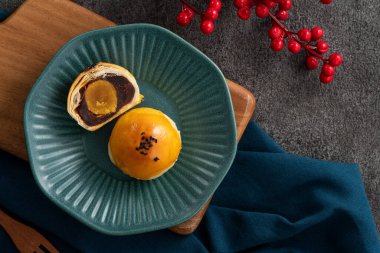 Design concept of Moon cake yolk pastry, mooncake for Mid-Autumn Festival holiday on gray table background