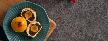 Design concept of Moon cake yolk pastry, mooncake for Mid-Autumn Festival holiday on gray table background