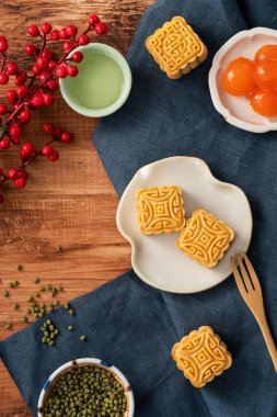Delicious mung bean moon cake for Mid-Autumn Festival food mooncake on gray table background for afternoon tea, holiday celebration serving.