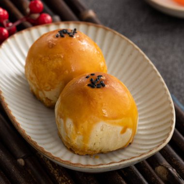 Design concept of Moon cake yolk pastry, mooncake for Mid-Autumn Festival holiday on dark gray table background