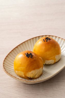 Design concept of Moon cake yolk pastry, mooncake for Mid-Autumn Festival holiday on wooden table background