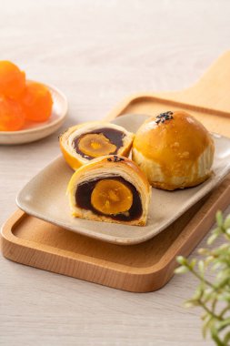 Design concept of Moon cake yolk pastry, mooncake for Mid-Autumn Festival holiday on wooden table background