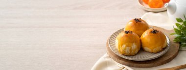 Design concept of Moon cake yolk pastry, mooncake for Mid-Autumn Festival holiday on wooden table background