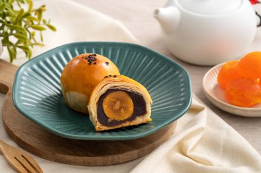 Design concept of Moon cake yolk pastry, mooncake for Mid-Autumn Festival holiday on wooden table background