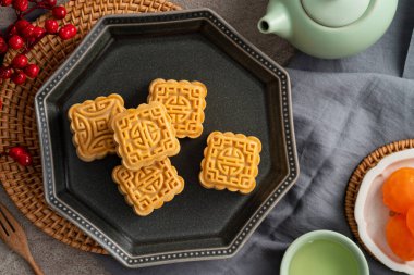 Delicious mung bean moon cake for Mid-Autumn Festival food mooncake on gray table background for afternoon tea, holiday celebration serving.
