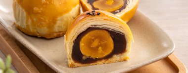 Design concept of Moon cake yolk pastry, mooncake for Mid-Autumn Festival holiday on wooden table background