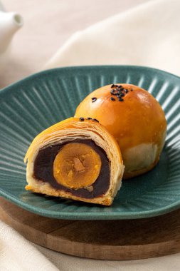 Design concept of Moon cake yolk pastry, mooncake for Mid-Autumn Festival holiday on wooden table background