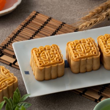 Delicious mung bean moon cake for Mid-Autumn Festival food mooncake on gray table background for afternoon tea, holiday celebration serving.