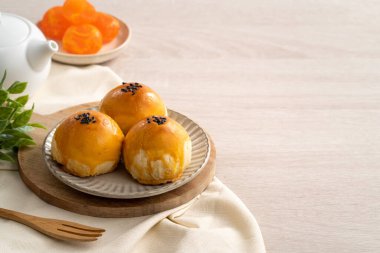 Design concept of Moon cake yolk pastry, mooncake for Mid-Autumn Festival holiday on wooden table background