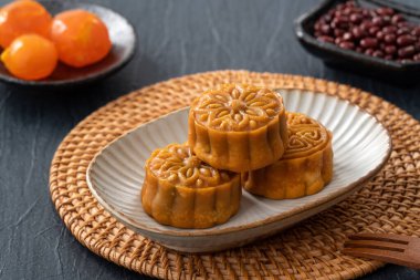 Delicious Cantonese moon cake for Mid-Autumn Festival food mooncake on blue table background for afternoon tea, holiday celebration serving.
