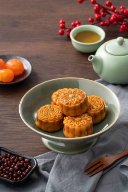 Delicious Cantonese moon cake for Mid-Autumn Festival food mooncake on wooden table background for afternoon tea, holiday celebration serving.