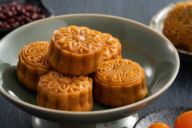 Delicious Cantonese moon cake for Mid-Autumn Festival food mooncake on blue table background for afternoon tea, holiday celebration serving.
