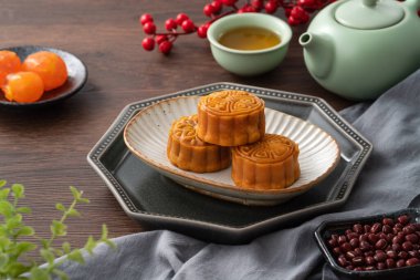 Delicious Cantonese moon cake for Mid-Autumn Festival food mooncake on wooden table background for afternoon tea, holiday celebration serving.
