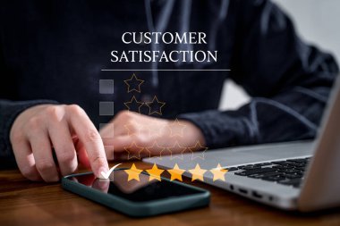 Customer using smart phone and laptop to rate their satisfaction ranking for experience review survey and comment
