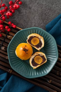 Design concept of Moon cake yolk pastry, mooncake for Mid-Autumn Festival holiday on gray table background