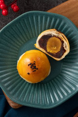 Design concept of Moon cake yolk pastry, mooncake for Mid-Autumn Festival holiday on gray table background