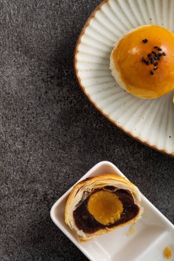 Design concept of Moon cake yolk pastry, mooncake for Mid-Autumn Festival holiday on gray table background