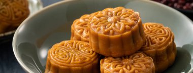 Delicious Cantonese moon cake for Mid-Autumn Festival food mooncake on blue table background for afternoon tea, holiday celebration serving.