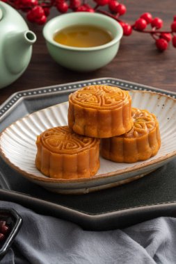 Delicious Cantonese moon cake for Mid-Autumn Festival food mooncake on wooden table background for afternoon tea, holiday celebration serving.