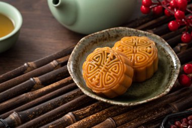 Delicious Cantonese moon cake for Mid-Autumn Festival food mooncake on wooden table background for afternoon tea, holiday celebration serving.