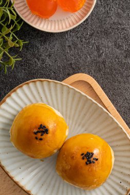 Design concept of Moon cake yolk pastry, mooncake for Mid-Autumn Festival holiday on gray table background