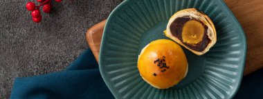 Design concept of Moon cake yolk pastry, mooncake for Mid-Autumn Festival holiday on gray table background