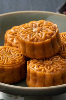 Delicious Cantonese moon cake for Mid-Autumn Festival food mooncake on wooden table background for afternoon tea, holiday celebration serving.