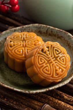 Delicious Cantonese moon cake for Mid-Autumn Festival food mooncake on wooden table background for afternoon tea, holiday celebration serving.