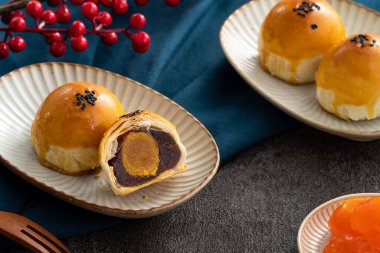 Design concept of Moon cake yolk pastry, mooncake for Mid-Autumn Festival holiday on dark gray table background