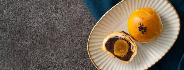 Design concept of Moon cake yolk pastry, mooncake for Mid-Autumn Festival holiday on gray table background