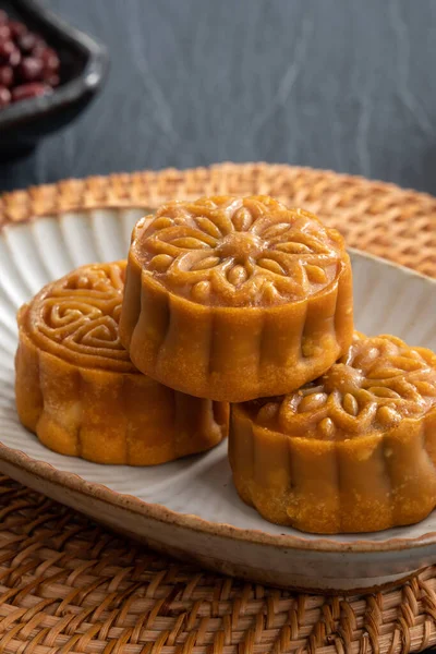 Delicious Cantonese moon cake for Mid-Autumn Festival food mooncake on blue table background for afternoon tea, holiday celebration serving.
