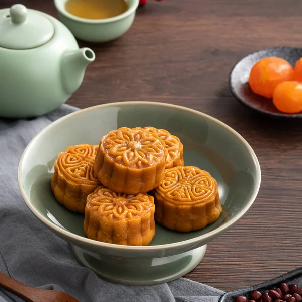 Delicious Cantonese moon cake for Mid-Autumn Festival food mooncake on wooden table background for afternoon tea, holiday celebration serving.