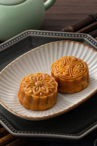 Delicious Cantonese moon cake for Mid-Autumn Festival food mooncake on wooden table background for afternoon tea, holiday celebration serving.