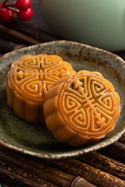Delicious Cantonese moon cake for Mid-Autumn Festival food mooncake on wooden table background for afternoon tea, holiday celebration serving.