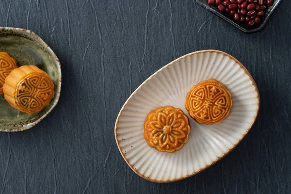 Delicious Cantonese moon cake for Mid-Autumn Festival food mooncake on blue table background for afternoon tea, holiday celebration serving.