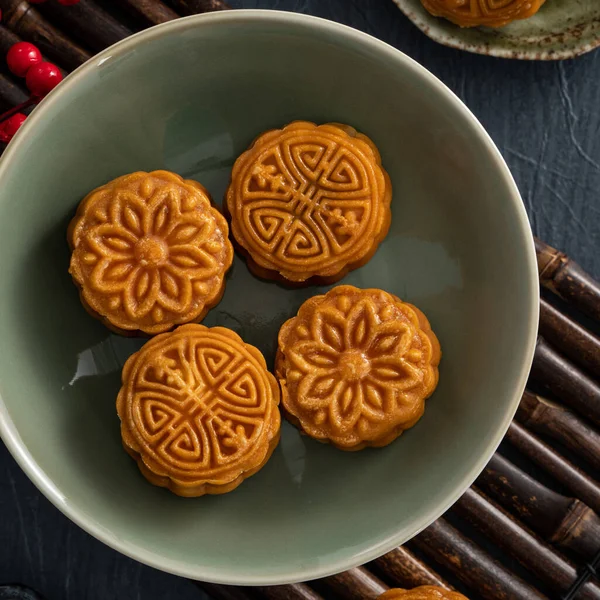 Delicious Cantonese moon cake for Mid-Autumn Festival food mooncake on blue table background for afternoon tea, holiday celebration serving.