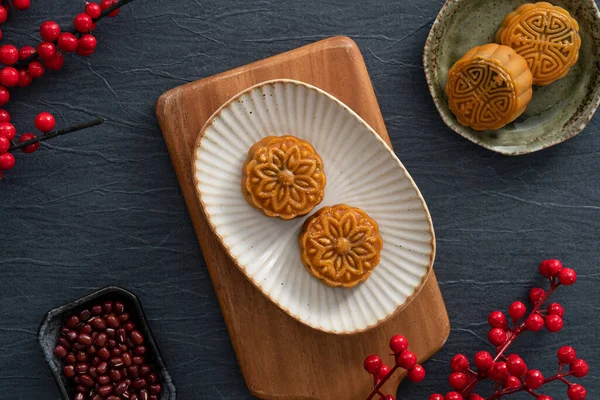 Delicious Cantonese moon cake for Mid-Autumn Festival food mooncake on blue table background for afternoon tea, holiday celebration serving.