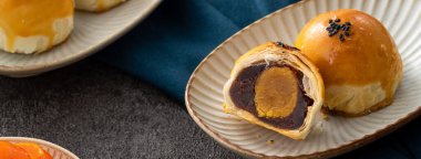 Design concept of Moon cake yolk pastry, mooncake for Mid-Autumn Festival holiday on dark gray table background