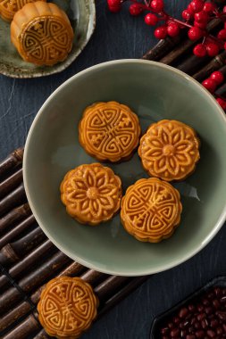 Delicious Cantonese moon cake for Mid-Autumn Festival food mooncake on blue table background for afternoon tea, holiday celebration serving.
