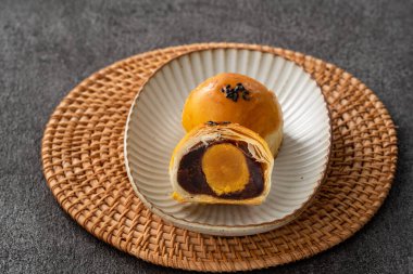 Design concept of Moon cake yolk pastry, mooncake for Mid-Autumn Festival holiday on dark gray table background