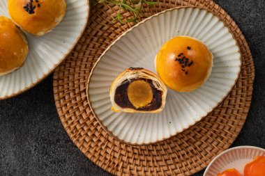 Design concept of Moon cake yolk pastry, mooncake for Mid-Autumn Festival holiday on gray table background