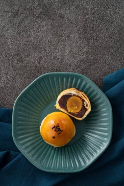 Design concept of Moon cake yolk pastry, mooncake for Mid-Autumn Festival holiday on gray table background