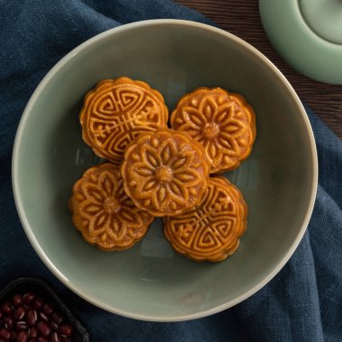 Delicious Cantonese moon cake for Mid-Autumn Festival food mooncake on wooden table background for afternoon tea, holiday celebration serving.
