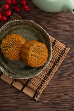 Delicious Cantonese moon cake for Mid-Autumn Festival food mooncake on wooden table background for afternoon tea, holiday celebration serving.