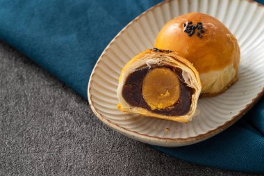 Design concept of Moon cake yolk pastry, mooncake for Mid-Autumn Festival holiday on dark gray table background