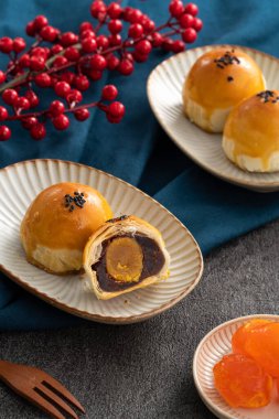 Design concept of Moon cake yolk pastry, mooncake for Mid-Autumn Festival holiday on dark gray table background